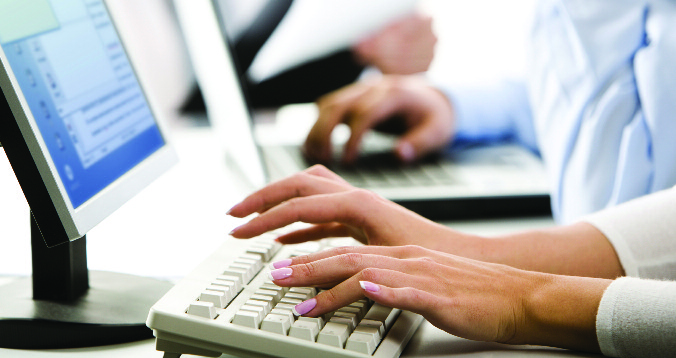 person typing on a keyboard using Square 9 document management software